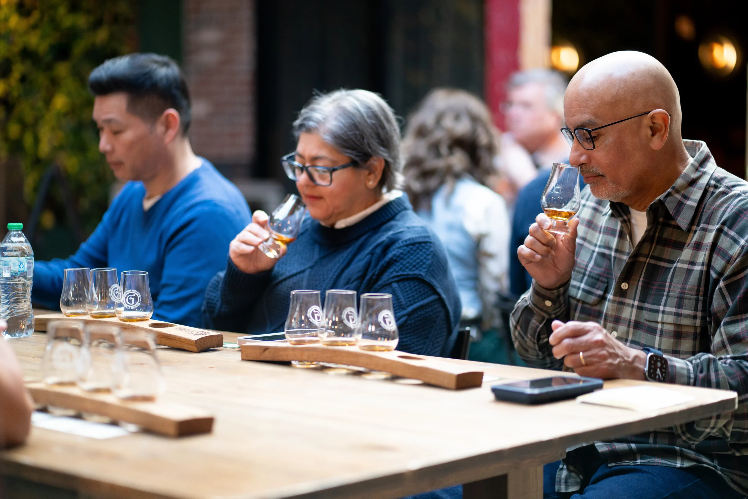 Guests sampling premium bourbon during a Nashville whiskey tasting tour at a local distillery.